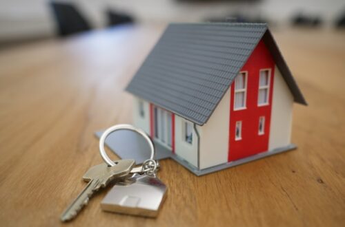 model of a house next to some house keys