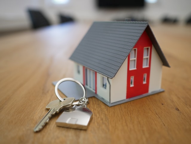model of a house next to some house keys